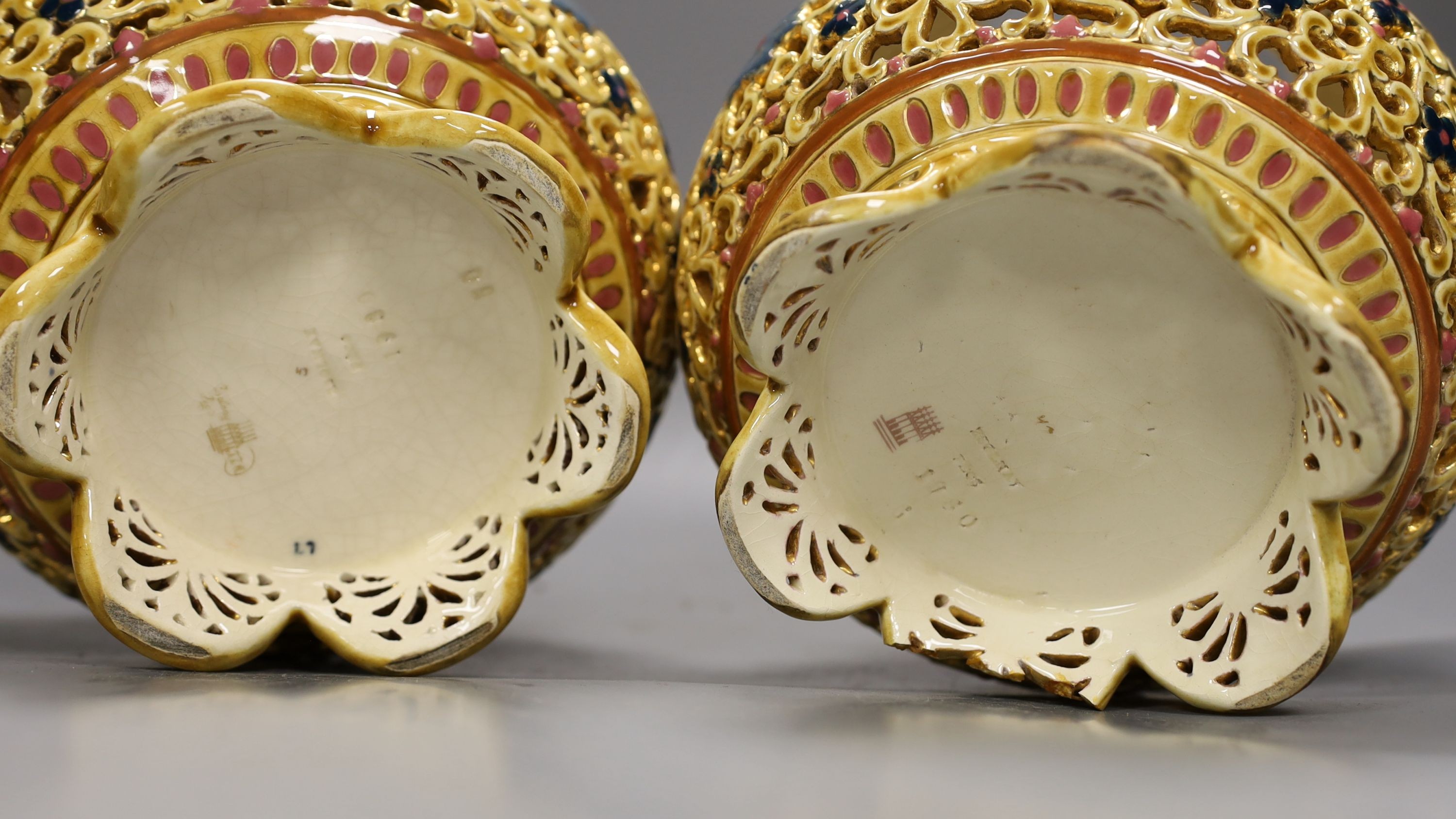 A pair of Zsolnay Pecs Persian inspired vases and covers, 27 cms high.